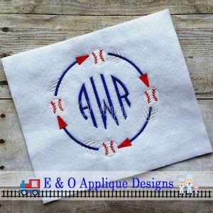 May include: A white fabric with a blue circle with white arrows and red points around the circle. Inside the circle is a blue monogram "AWR" and four white baseballs with red stitching.