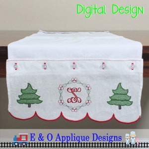 May include: White table runner with a red scalloped edge and embroidered Christmas trees and a monogram in a wreath. The text "Digital Design" is at the top of the image.