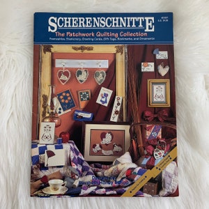 May include: A book titled "Scherenschnitte: The Patchwork Quilting Collection" with a colorful image of a room decorated with patchwork quilting projects. The book features designs by Elizabeth Haney Bishop and includes instructions for creating frameables, stationery, greeting cards, gift tags, bookmarks, and ornaments.
