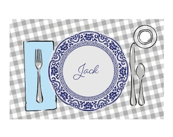 May include: A blue and white patterned dinner plate with the name "Jack" written in cursive on the center. The plate is set on a gray and white checkered tablecloth with a fork, knife, and spoon.