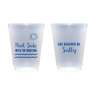 May include: Two clear plastic cups with blue text. The left cup says "Pool Side with the Martins" and has a sun and waves graphic. The right cup says "Cuz Beaches Be Salty".