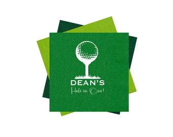 May include: Green and white golf-themed paper napkins with the text "DEAN'S Hole in One!" printed on them.