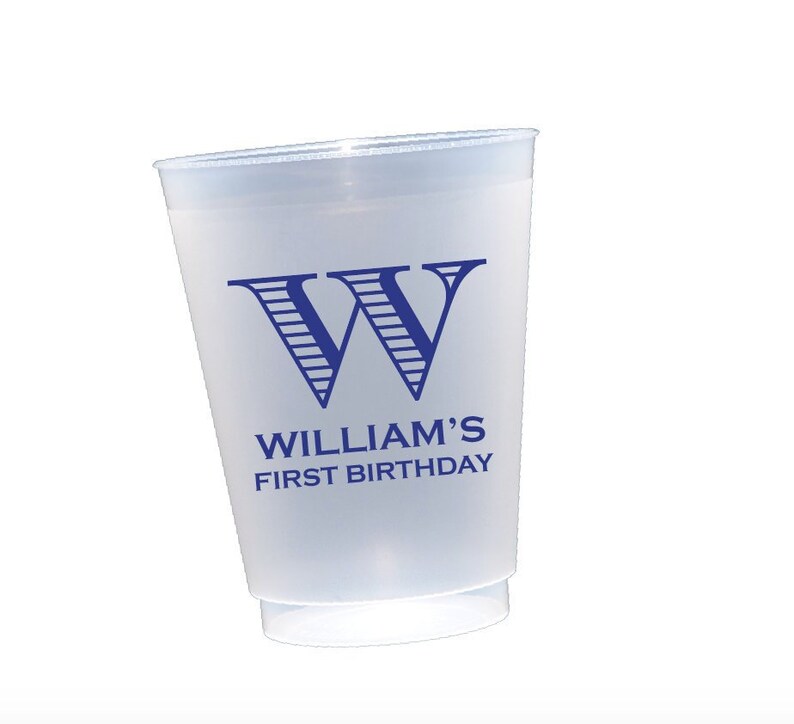 May include: A clear plastic cup with a blue and white striped letter "W" and the text "William's First Birthday" printed on the side.
