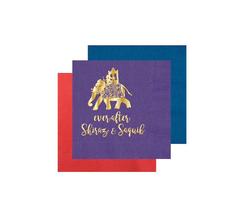 May include: Purple and red paper napkins with a gold elephant design and the text "ever after Shiraz & Saquib".