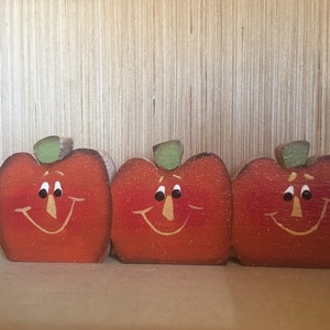 Three little pumpkins in a row. Connected together. Can be personalized with little pumpkins names.