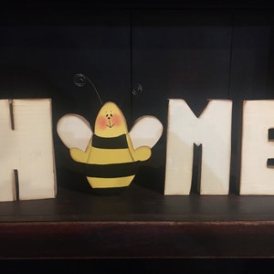 Farmhouse white letters With a bee in place of the 0. Fun summer decoration. They measure about 5 inches tall by 3 inches wide.