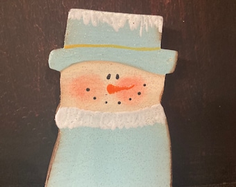 Cute snowman wearing his blue coat and hat.