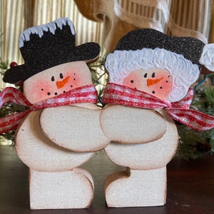 Cute wood snow couple shelf sitter. Can be personalized.