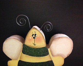 Wooden yellow bee. 3 inches  tall by 3 1/2 inches wide.