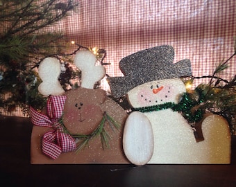 Wood snowman with his deer.