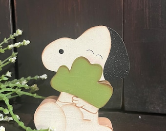 White beagle hugging shamrock.