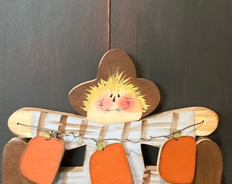 Scarecrow shelf sitter. Holding pumpkins.Pumpkins can be personalized.
