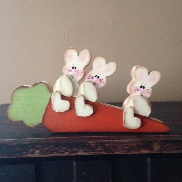 Three bunnies sittin' on a carrot. The bunnies can be personalized.