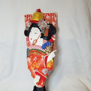 Vintage Japanese kabuki Hagoita Asian doll on a hanging wooden paddle