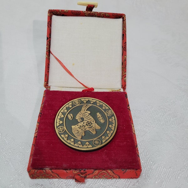 Brass Chinese zodiac coin, year of the goat, in its own padded case