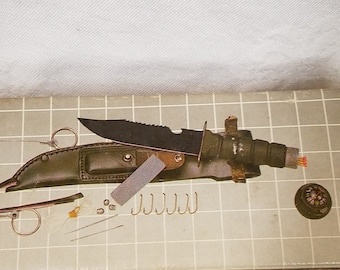Vintage survival knife with compass, matches, leads, needles, fishing hooks, nylon line, sharpening stone, wire saw, Made in Taiwan