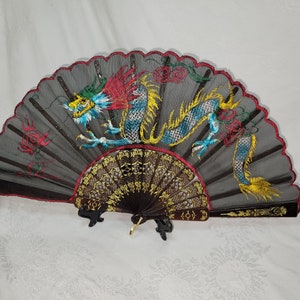 Vintage fabric fold out fan with a dragon picture