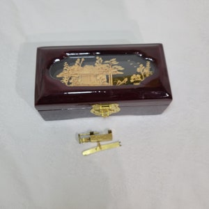 Vintage Asian locking maroon lacquer jewelry box with cork art in the lid and a red lined cushioned drawer