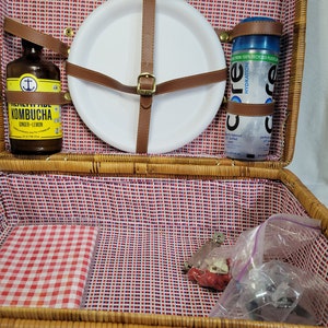 Vintage wicker picnic basket with handles, including picnic accessories