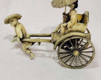 Vintage celluloid geisha in a rickshaw