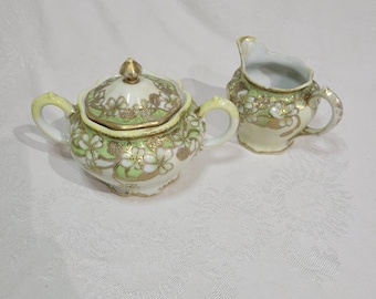 Vintage moriage creamer and lidded sugar bowl,  marked Oriental China Nippon