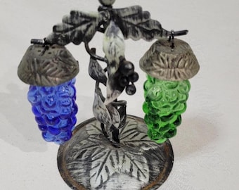 Vintage green and blue grape cluster salt and pepper shakers hanging on a grape vine