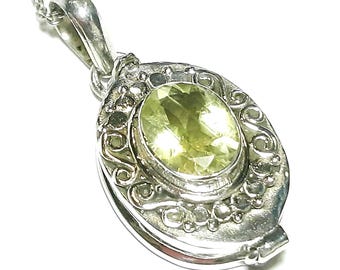 May include: Silver-toned pendant necklace featuring an oval, light green gemstone. The gemstone is set in a decorative, ornate silver setting with a detailed design. The pendant hangs from a delicate silver chain, creating an elegant jewelry piece.