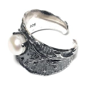 May include: A silver ring with a textured, leaf-like design and a white pearl. The ring is marked with the number "926".