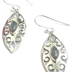 May include: Silver dangle earrings with a delicate, ornate design and a gray gemstone in the center.