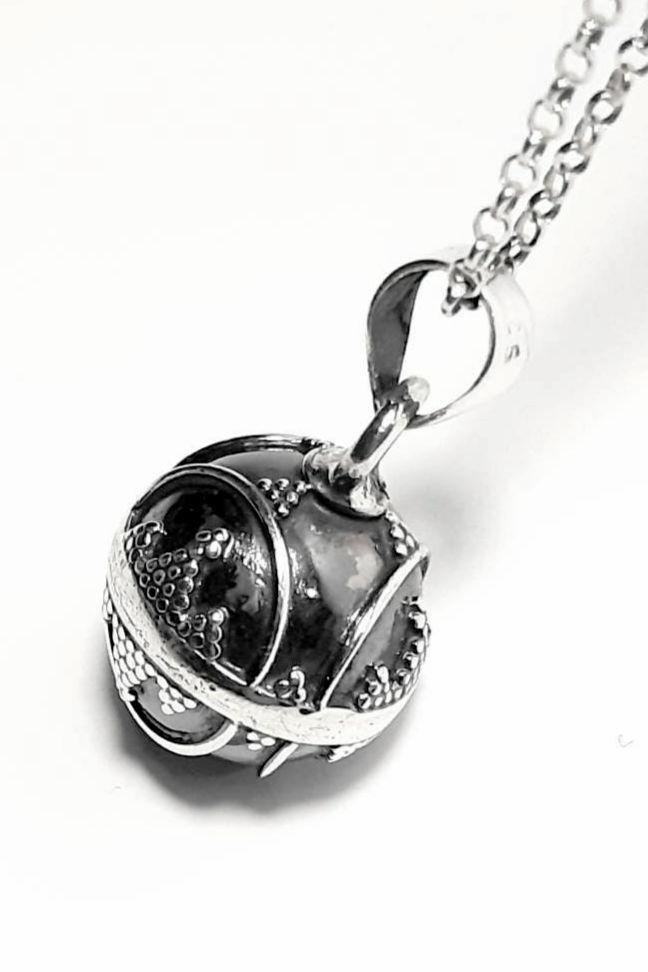 a Mexican Bola, chime pendant, harmony ball, angel caller