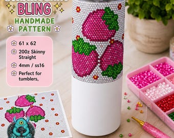 May include: A cylindrical tumbler featuring a partial strawberry pattern created with small, sparkling rhinestones. The upper portion displays pink and green strawberry motifs, while the lower section is plain white. A metal straw is inserted in the lid.