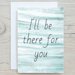 May include: A card with a blue and white watercolour background and the text "I'll be there for you" written in black.