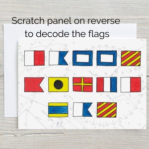 May include: A set of ten nautical signal flags, each with a different colour and design, printed on a white background. The flags are arranged in two rows of five. The flags are used to communicate messages at sea. The text "Scratch panel on reverse to decode the flags" is printed at the top of the image.