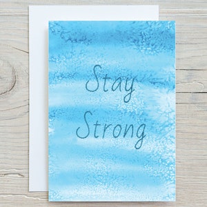 May include: A blue watercolour card with the text "Stay Strong" in dark blue.