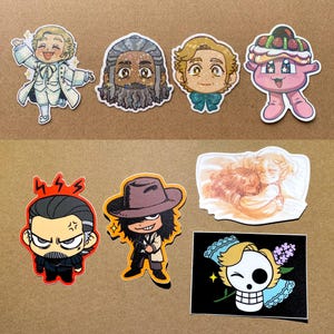 May include: A collection of colorful cartoon stickers featuring various characters. The stickers include a figure in a white coat, a character with a beard, a character with a bow tie, a pink creature with a dessert on its head, and more.