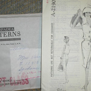 May include: A vintage sewing pattern envelope with a black and white illustration of a woman wearing a dress and hat. The pattern number is A-2190. The envelope is labeled "Spadea Patterns by World Famous Designers".
