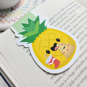 May include: A yellow pineapple with a friendly face is holding a slice of pizza and a red soda can. The pineapple has a green leafy top and is on a white background.