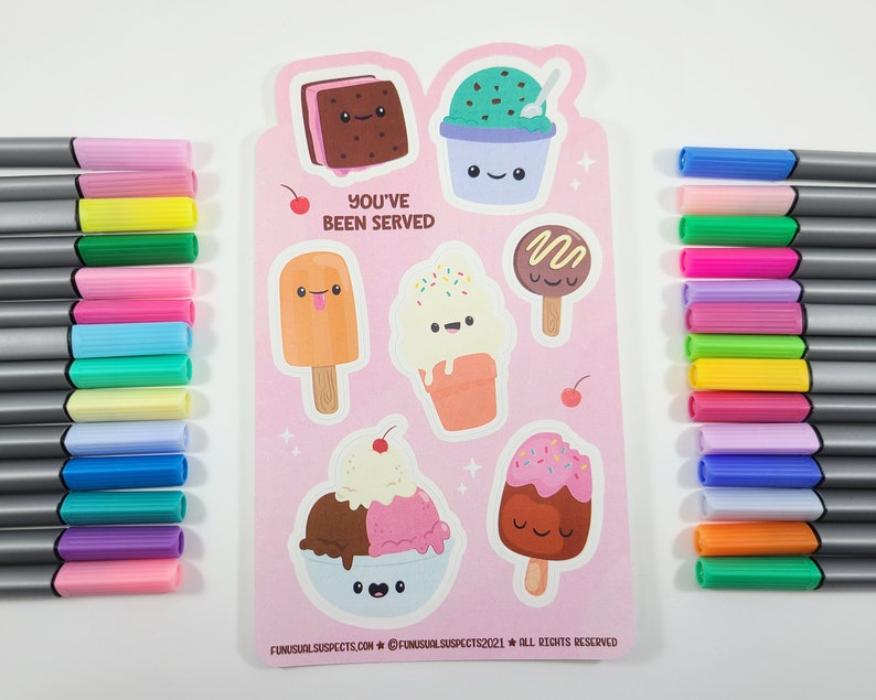 May include: A pink sticker sheet featuring various ice cream designs with smiling faces and the text "YOU'VE BEEN SERVED." The sheet is surrounded by colorful markers in shades of pink, green, blue, and yellow.
