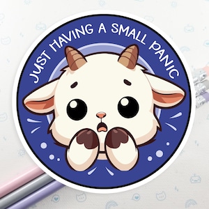 May include: A blue and white sticker with a cartoon goat with big eyes and a surprised expression. The text "JUST HAVING A SMALL PANIC" is written around the goat.