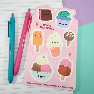 May include: A pink sticker sheet featuring various ice cream designs with smiling faces. The sheet includes ice cream sandwiches, sundaes, and popsicles. The text "YOU'VE BEEN SERVED" is printed on the sheet. Two pens, one teal and one pink, are on the left.