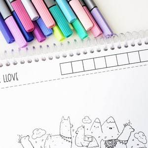 May include: A coloring book with a llama theme. The cover features a black and white illustration of llamas, mountains, and clouds. The book has a spiral binding and a color test section.