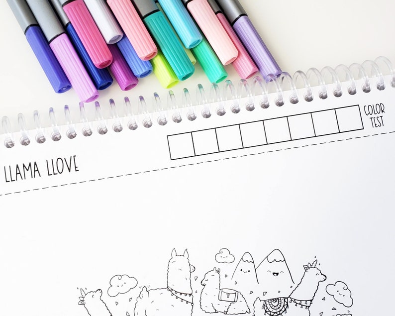 May include: A coloring book with a llama theme. The cover features a black and white illustration of llamas, mountains, and clouds. The book has a spiral binding and a color test section.