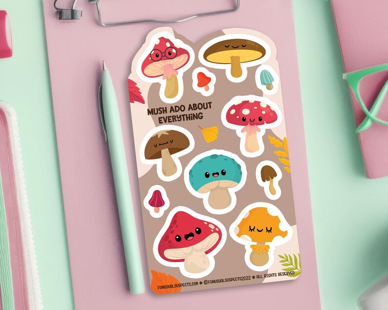 May include: A sheet of colorful mushroom stickers with cute faces. The stickers feature different colors and designs, including red, brown, and yellow. The text "Mush Ado About Everything" is printed on the sheet.