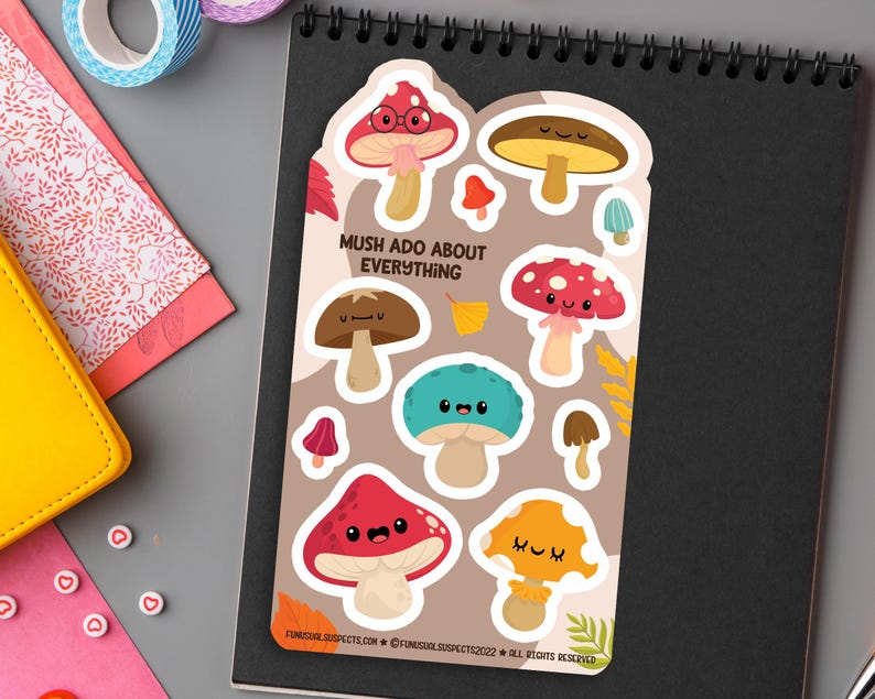 May include: A sheet of colorful mushroom stickers with cute faces. The stickers feature different colors and designs, including red, brown, blue, and yellow. The text "Mush Ado About Everything" is printed on the sheet.