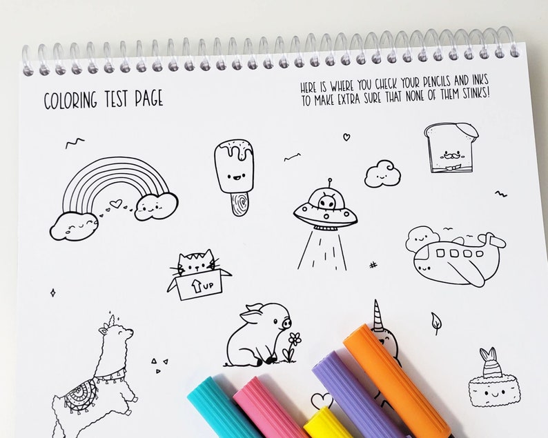 May include: A coloring test page with a variety of black and white illustrations, including a rainbow, ice cream, a UFO, a plane, a cat in a box, a pig, a llama, and a cake. The page is designed to help users test their pencils and inks to make sure they are working properly. The text on the page reads "COLORING TEST PAGE" and "HERE IS WHERE YOU CHECK YOUR PENCILS AND INKS TO MAKE EXTRA SURE THAT NONE OF THEM STINKS!"