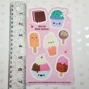 May include: A sheet of stickers featuring various ice cream treats with cute faces. Designs include an ice cream sandwich, a sundae, a popsicle, a cone, and a chocolate-covered ice cream bar. The text "YOU'VE BEEN SERVED" is also included.