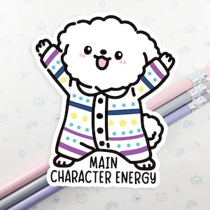 May include: White cartoon dog wearing a purple, blue, and yellow striped shirt with stars and the text "Main Character Energy".