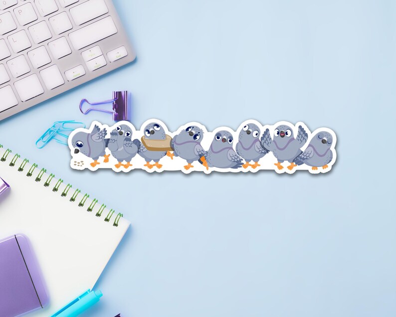 May include: A sticker featuring a line of cartoon pigeons in various poses. The pigeons are primarily gray with orange feet and beaks. One pigeon wears a tan scarf. The sticker is on a light blue surface with office supplies.
