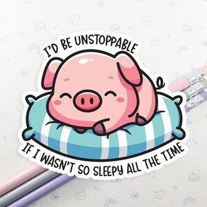 May include: A pink pig cartoon character with a big smile is sleeping on a blue and white striped pillow. The text reads "I'd be unstoppable if I wasn't so sleepy all the time."