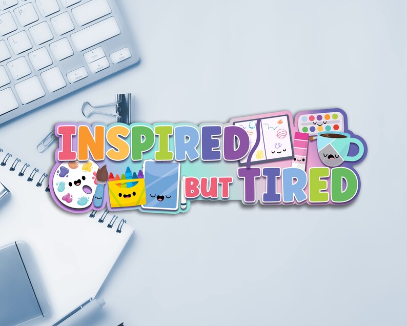 May include: A colorful graphic design with the text "Inspired but Tired" featuring a paint palette, paintbrushes, crayons, a notebook, a coffee cup, and a paint can with cute cartoon faces.